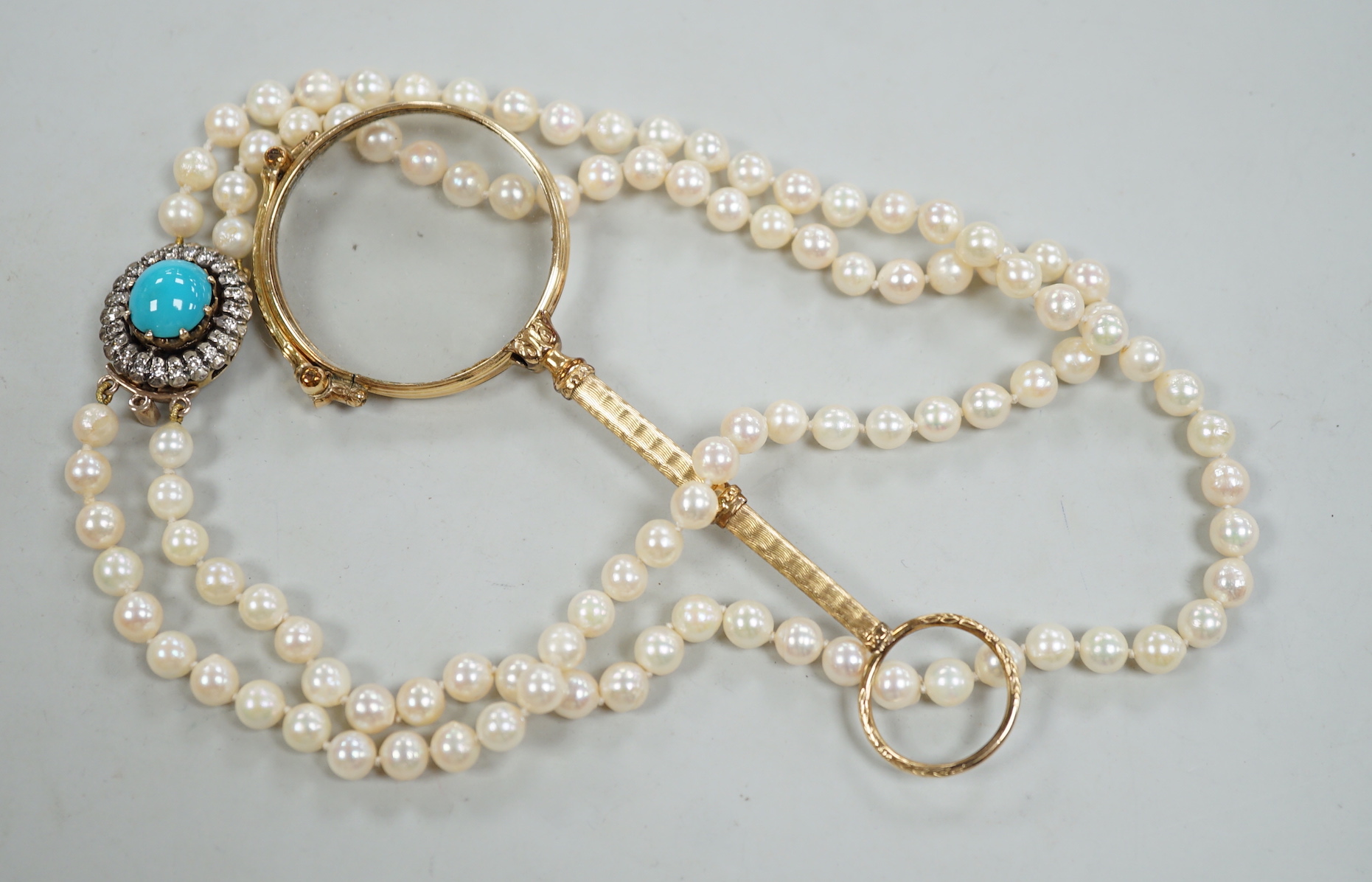 A twin strand cultured pearl choker necklace with yellow metal, blue enamel and diamond cluster set clasp, 36cm, together with a pair of yellow metal overlaid lorgnettes.